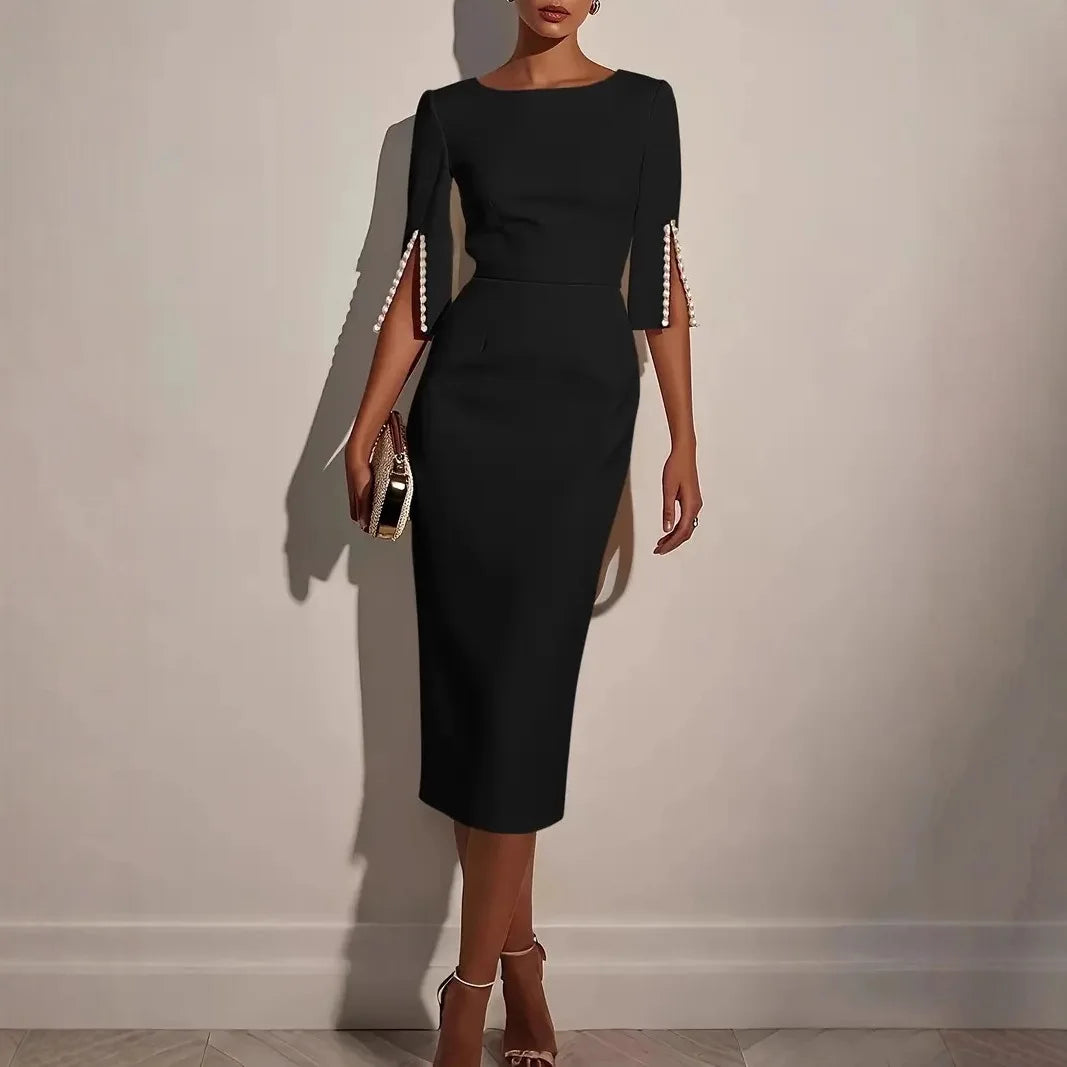 LUCIA - ELEGANTE JURK MET OPEN MOUWEN GERAFFD MET PARELS